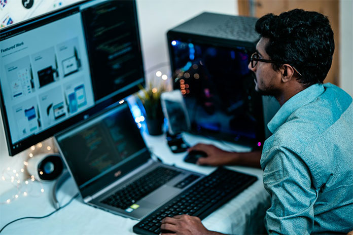 A person working on a computer using AI knowledge management systems